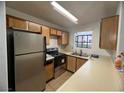 Efficient kitchen featuring stainless steel appliances and wood cabinets at 2961 Juniper Hills Blvd # 102, Las Vegas, NV 89142