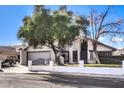 House exterior showcasing a gray garage door and a white fence at 4705 Rockvale Dr, Las Vegas, NV 89103