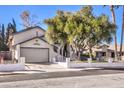 Single-story home with a gray garage door and a landscaped yard at 4705 Rockvale Dr, Las Vegas, NV 89103