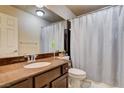 Bathroom with granite countertop, shower/tub combo, and wood vanity at 5957 Pillar Rock Ave, Las Vegas, NV 89139