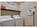 Bright laundry room with washer, dryer, and shelving at 5957 Pillar Rock Ave, Las Vegas, NV 89139