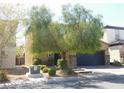 Inviting two-story home with a two-car garage and charming desert landscaping in a desirable neighborhood at 647 Wounded Star Ave, Las Vegas, NV 89178