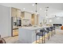 Modern kitchen features marble countertops, stainless steel appliances, and a breakfast bar at 10981 Laureldale Ct, Las Vegas, NV 89141