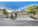 Charming single-story home with a three-car garage, desert landscaping, and inviting curb appeal at 11119 Cantoria Ct, Las Vegas, NV 89141