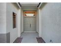 Inviting entryway with a double door entrance and textured stucco walls, leading to a bright interior at 11119 Cantoria Ct, Las Vegas, NV 89141