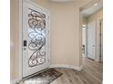 Elegant foyer with decorative glass door, hardwood floors, and neutral wall colors at 1143 Tortoise Mountain Dr, Mesquite, NV 89034