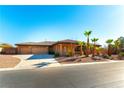 House with three-car garage, desert landscaping, and a walkway to the entry at 5024 Crown Cypress St, Las Vegas, NV 89149