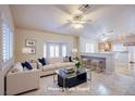 Living room features a beige couch, coffee table, and kitchen bar at 5123 Mascaro Dr, Las Vegas, NV 89122