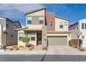 Contemporary two-story house with a green garage door and landscaping at 540 Front Range Ln, North Las Vegas, NV 89084