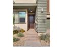 Inviting front entrance with dark brown door and stone pathway at 540 Front Range Ln, North Las Vegas, NV 89084