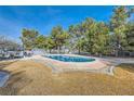 Inviting swimming pool with surrounding lawn and trees at 7000 W Rome Blvd, Las Vegas, NV 89131