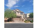 Two-story house with a brown garage door and landscaped yard at 7914 Torreys Peak St, Las Vegas, NV 89166