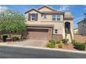 Two story house with a brown garage door and landscaping at 7914 Torreys Peak St, Las Vegas, NV 89166