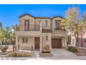 Two-story house with balcony, two-car garage, and landscaped yard at 9157 Chenille Ct, Las Vegas, NV 89149