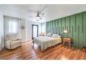 Spacious main bedroom with wood flooring, a green accent wall, and a king-size bed at 9157 Chenille Ct, Las Vegas, NV 89149