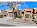 Tan one-story house with a brown door and two-car garage at 9452 Gold Mountain Dr, Las Vegas, NV 89134