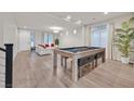 Spacious living room with pool table and modern furniture at 9753 Russian Hill St, Las Vegas, NV 89141