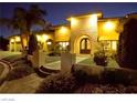 Close up of the exterior elevation featuring an arched entry and professionally landscaped yard at 2111 Bogart Ct, Las Vegas, NV 89117