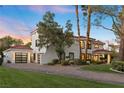 Beautiful white home with a modern garage door and landscaping at 2225 Versailles Ct, Henderson, NV 89074