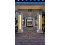 Inviting entryway with a glass door and brick flooring at 2225 Versailles Ct, Henderson, NV 89074