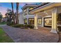 Elegant entryway with a brick walkway and modern lighting at 2225 Versailles Ct, Henderson, NV 89074