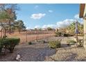 Landscaped backyard with gravel and a metal fence at 3455 Halter Dr, Las Vegas, NV 89122