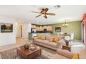 Spacious living room with neutral colored couch and kitchen view at 3455 Halter Dr, Las Vegas, NV 89122