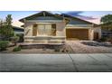 Single-story home with inviting front porch and brick driveway at 480 Heritage Bridge Ave, Henderson, NV 89011