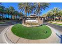 Grand Legacy community entrance, featuring a stone sign and palm trees at 1849 Indian Bend Dr, Henderson, NV 89074