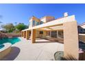 Inviting pool area with pergola, spacious patio, and lush landscaping at 1849 Indian Bend Dr, Henderson, NV 89074