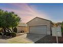 Single-story house with gray garage door and desert landscaping at 2185 Indigo Creek Ave, Henderson, NV 89012