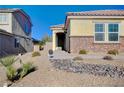 Landscaped front yard with desert landscaping and stone accents at 2452 Blair Castle St, Henderson, NV 89044