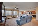 Spacious living room with a large sectional sofa and open kitchen at 2452 Blair Castle St, Henderson, NV 89044