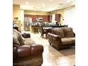 Open concept kitchen with island, stainless steel appliances, and dining area at 3641 Via Terracina, Henderson, NV 89052