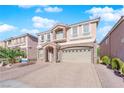 Two-story house with stone accents and a three-car garage at 6360 Stag Hollow Ct, Las Vegas, NV 89139