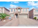 Two-story house with stone accents and a three-car garage at 6360 Stag Hollow Ct, Las Vegas, NV 89139