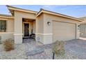 Inviting front entrance with stone pathway, dark entry door and two car garage at 2395 Dalewood Ave, North Las Vegas, NV 89086