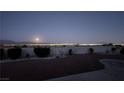 Night view of backyard with city lights and moonlit sky at 2904 Bow Bridge Dr, Las Vegas, NV 89134