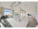 Open floor plan with a contemporary dining area boasting a modern light fixture and a view of the landscape at 2904 Bow Bridge Dr, Las Vegas, NV 89134