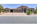 Elegant home featuring a three-car garage and meticulously landscaped front yard at 3906 Jacob Lake Cir, Las Vegas, NV 89118