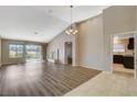 Bright living room featuring wood floors, a fireplace, vaulted ceilings, and sliding glass doors at 8805 Litchfield Ave, Las Vegas, NV 89134