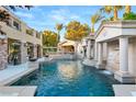 Resort-style pool with a waterfall, grotto, and spacious patio at 10308 Rocky Mesa Ct, Las Vegas, NV 89144