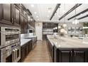 Spacious kitchen with dark wood cabinetry and stainless steel appliances at 12456 Edinburgh Cask Ave, Las Vegas, NV 89138