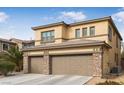 Two-story house with a three-car garage and stone accents at 1932 Barrow Glen Ct, North Las Vegas, NV 89084