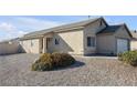 Single-story house with a white garage door and rock landscaping at 2005 Ona Marie Ave, North Las Vegas, NV 89032