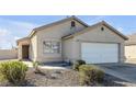 Single-story house with a white garage door and desert landscaping at 2005 Ona Marie Ave, North Las Vegas, NV 89032