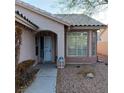 Inviting front entrance with a covered entryway and large windows at 2108 Buckeye Reef St, Henderson, NV 89002