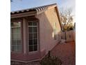 View of the home's side, featuring a gated access and large windows at 2108 Buckeye Reef St, Henderson, NV 89002