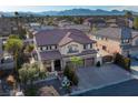 Two-story house with a three-car garage, pool, and mountain views at 3115 Azure Bay St, Las Vegas, NV 89117