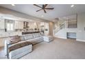 Open living room with sectional sofa and view of kitchen at 3267 Royal Fortune Dr, Las Vegas, NV 89141